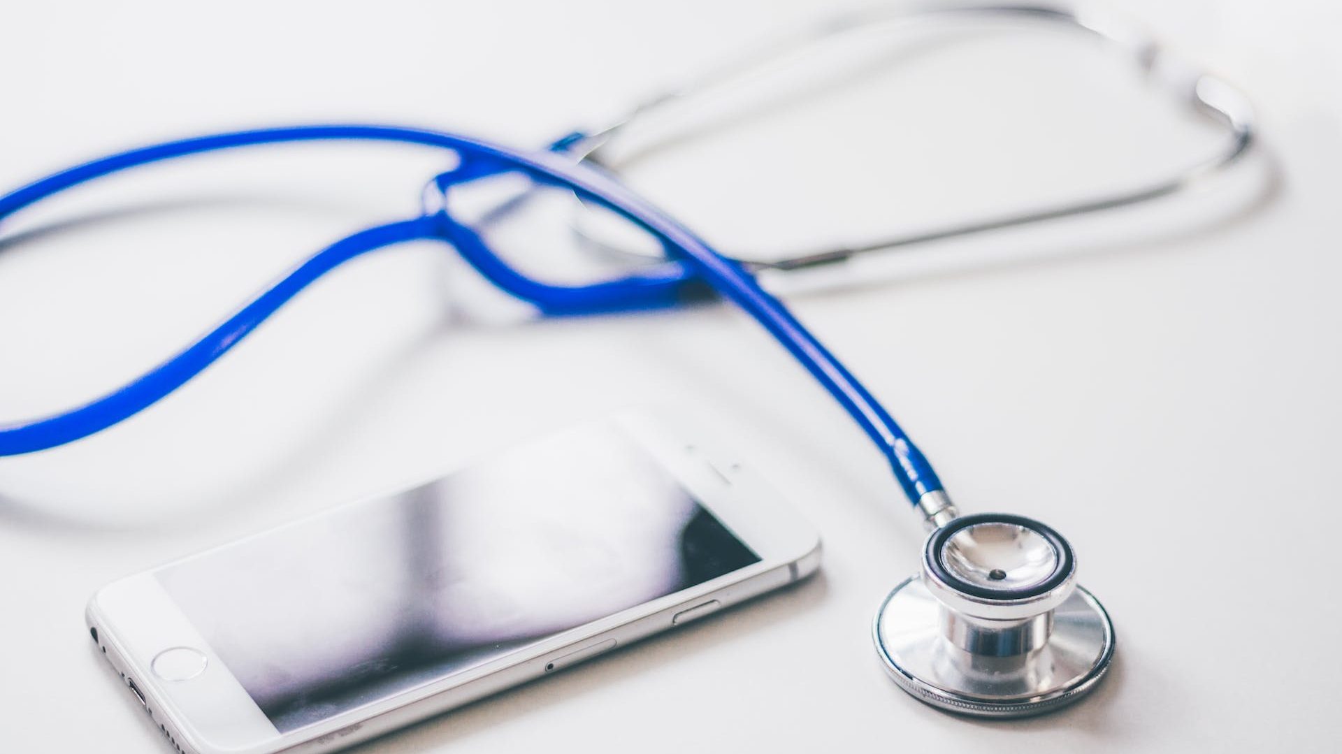 Silver Iphone 6 Near Blue and Silver Stethoscope
